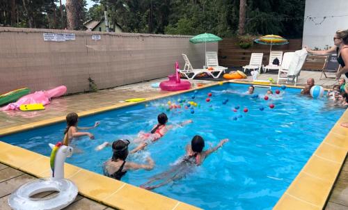 a group of children playing in a swimming pool at 3 WIOSŁA Brzozowa Zatoka in Brenno