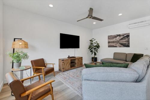 a living room with a couch and a flat screen tv at Newly furnished 5BD 4BA Townhome The Vue 30 in St. George