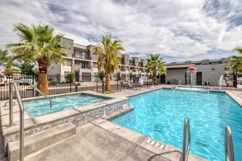 a swimming pool with palm trees in front of a building at Newly furnished 5BD 4BA Townhome The Vue 30 in St. George