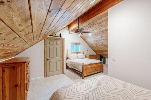 a bedroom with a bed and a wooden ceiling at Whispering Pines Retreat in Camp Connell