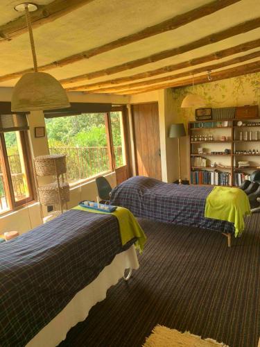 a bedroom with two beds and a window at Casa de Campo en Tabio Cundinamarca in Tabio