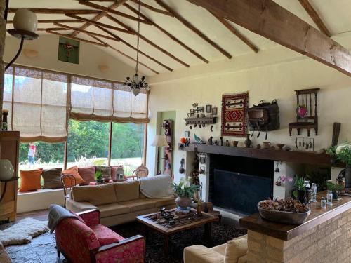 a living room with a couch and a fireplace at Casa de Campo en Tabio Cundinamarca in Tabio