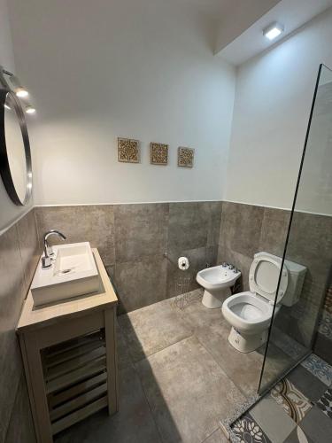 a bathroom with a toilet and a sink at Don Tino in San Pedro
