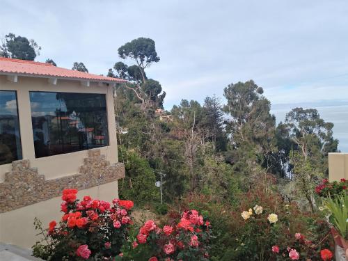 a view from the balcony of a house with flowers at Palacio del Inca Lodge in Comunidad Yumani
