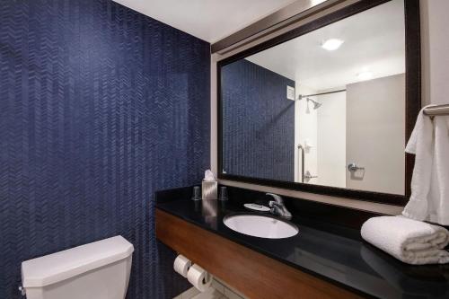 a bathroom with a sink and a mirror at Fairfield Inn and Suites by Marriott Rochester West/Greece in Rochester