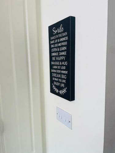 a black refrigerator with a sign on the door at Teach Biddy Rua Dungloe Townhouse in Dungloe