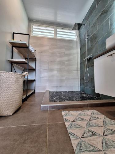 a bathroom with a shower and a bench in a room at FARE HEI - Maison 2 chambres avec Piscine privée et accès plage in Moorea
