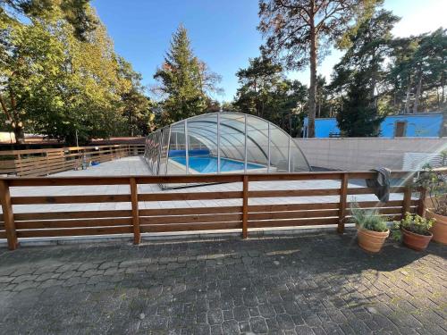 a glass dome on top of a wooden fence at 3 WIOSŁA Brzozowa Zatoka in Brenno