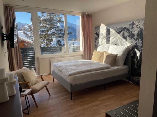 a bedroom with a bed in front of a window at NEST'L Appartements & Zimmer in Mösern