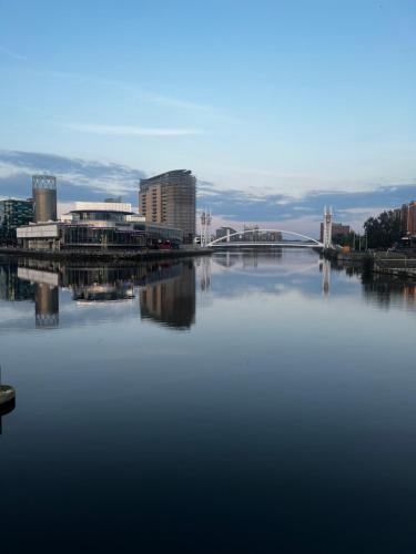 a large body of water with buildings and a bridge at Quartz manor in Manchester