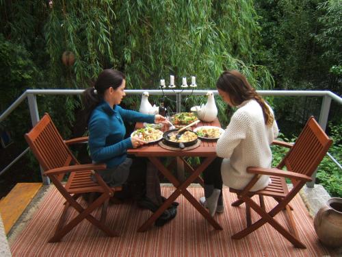 two women sitting at a table with food at Shantee House in Budapest