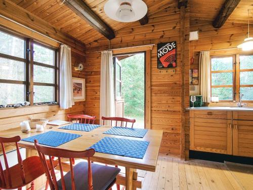 a dining room with a table in a cabin at 4 person holiday home in Store Fuglede-By Traum in Store Fuglede