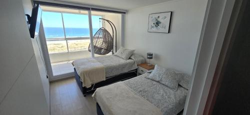 En eller flere senge i et værelse på Departamento Laguna del Mar