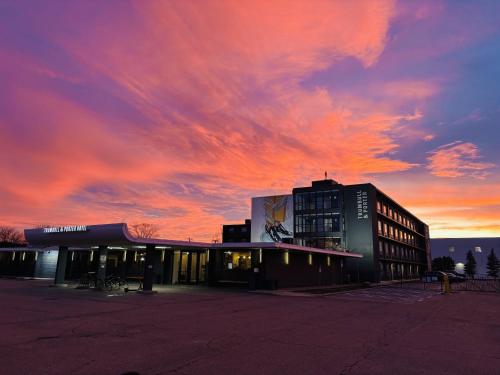 a building with a sunset in the background at Trumbull and Porter - Detroit Downtown in Detroit