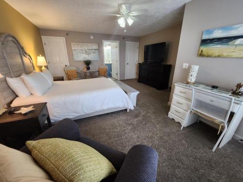a bedroom with a white bed and a couch at North Shore Inn TC 305 in Traverse City