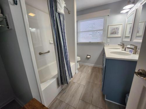 a bathroom with a sink and a toilet and a shower at North Shore Inn TC 305 in Traverse City