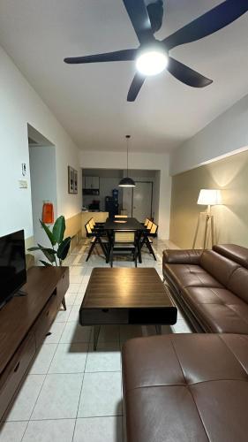 a living room with a couch and a ceiling fan at Vista Home in Kajang