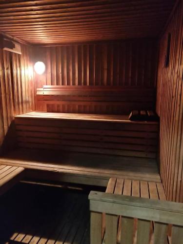 an empty wooden sauna with a bench in it at Garden House By IsrApart in Ra‘ananna