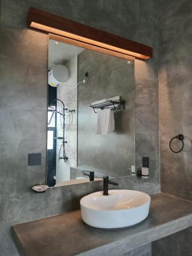 a bathroom with a sink and a mirror at Surftunnel Beach Resort in Weligama