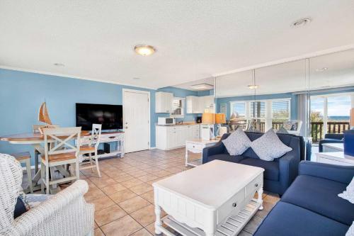 a living room with a couch and a table at Ocean front Rental 101-2 in Tybee Island