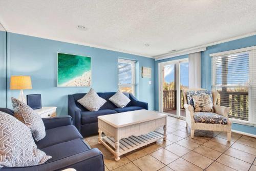 a living room with a couch and a table at Ocean front Rental 101-2 in Tybee Island