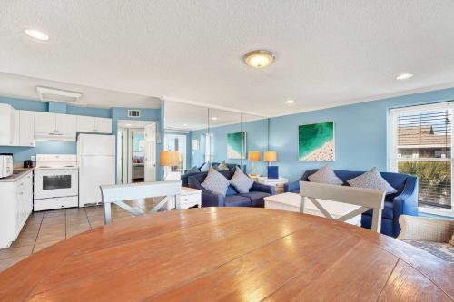a kitchen and living room with a large wooden table at Ocean front Rental 101-2 in Tybee Island