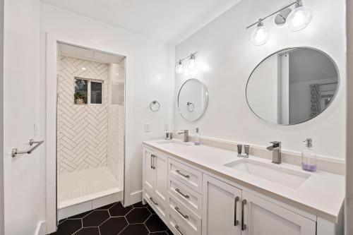 a white bathroom with a sink and a mirror at SI2995: 2995 Seabrook Island Rd. in Seabrook Island