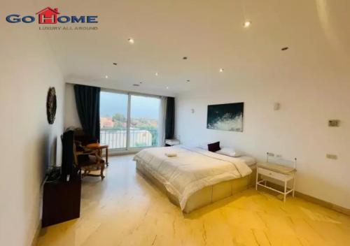 a bedroom with a large bed and a large window at Pretty 4Bedrooms Penthouse MB7 at New Abu Tig Marina in Hurghada