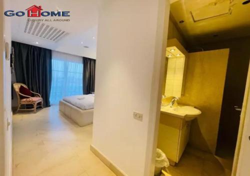 a bathroom with a sink and a bed in a room at Pretty 4Bedrooms Penthouse MB7 at New Abu Tig Marina in Hurghada