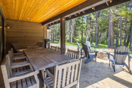 a wooden deck with a table and chairs on a patio at Suncadia 4 Bdrm Luxury Home in Cle Elum
