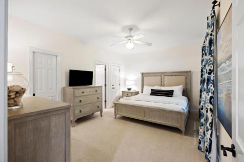 a bedroom with a bed and a tv and a dresser at SM14: 14 Silver Moss in Kiawah Island