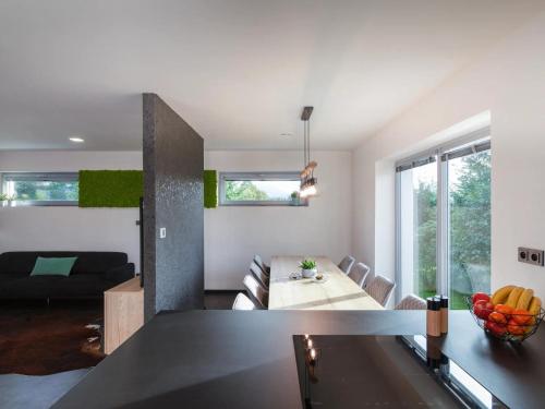 a living room with a table and a couch at Charming Home in Frýdlant with Jacuzzi & Cinema in Frýdlant nad Ostravicí
