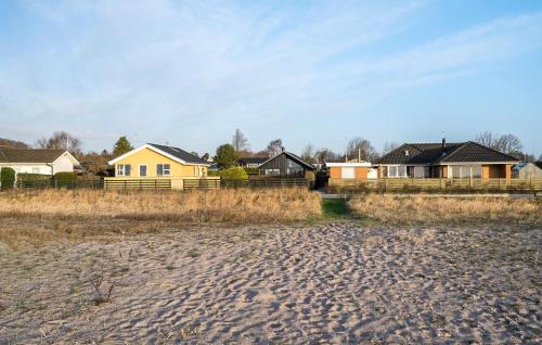 a house on a beach with houses in the background at Stunning Home In Haderslev With Wifi in Haderslev
