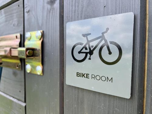 a sign on a door with a bike on it at Villa in Doksy near Macha Lake in Doksy
