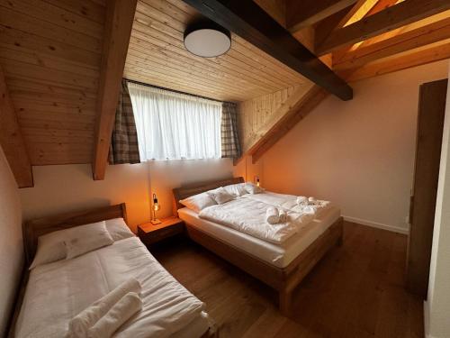 an attic bedroom with two beds and a window at Apartment in Cerny Dul near Ski Resort in Cerny Dul