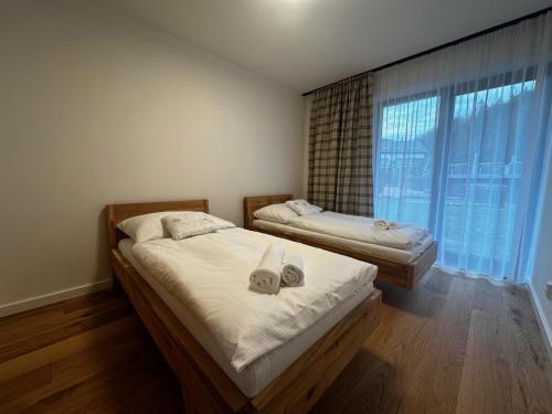 a bedroom with two beds and a large window at Apartment in Cerny Dul near SkiResort in Cerny Dul