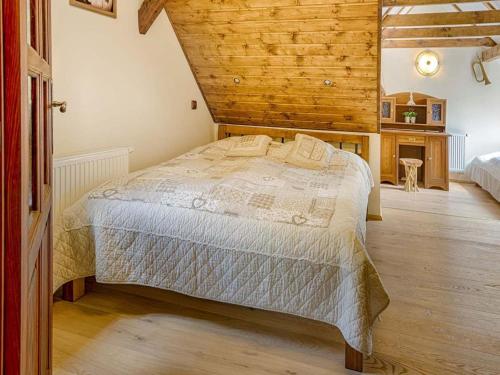 a bedroom with a bed and a wooden wall at Chalet in Liberec near Ski Resort Jested in Světlá pod Ještědem