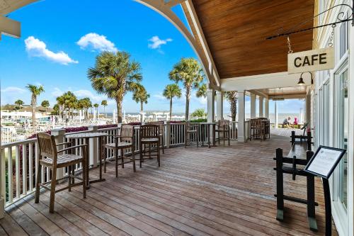 a deck with tables and chairs on the beach at SL912: 912 Sealoft in Seabrook Island