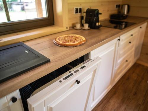 a pizza sitting on top of a counter in a kitchen at Villa in Beskydy near Ski Slopes in Velké Karlovice