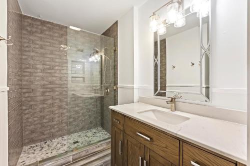 a white bathroom with a sink and a shower at SG7A: 7A Seagrove Villa in Isle of Palms