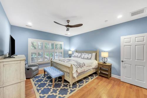a bedroom with blue walls and a bed and a tv at SI2638: 2638 Seabrook Island Road in Seabrook Island