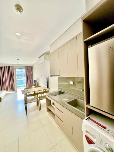 a kitchen with a table and a dining room at The Song Apartment 5 Stars Vung Tau - Căn Hộ Du Lịch 5 Sao Cạnh Biển - Dumin's Homestay in Vung Tau