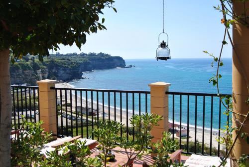 a balcony with a view of the beach at Hotel Rocca Della Sena in Tropea