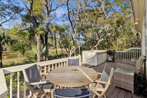 a wooden table and chairs on a deck at MH3012: 3012 Marsh Haven in Seabrook Island
