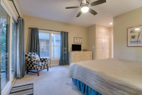 a bedroom with a bed and a chair and a window at SM04: 4 Silver Moss in Kiawah Island