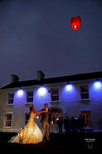 a bride and groom dancing in front of a building at Greenvale Hotel in Cookstown