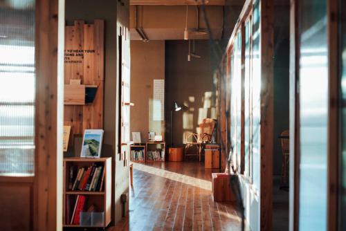 a room with a hallway with a book shelf at Star Hostel Taichung Parklane in Taichung