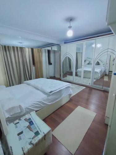 a bedroom with a large bed and a large mirror at شقق Hs 4 in Cairo
