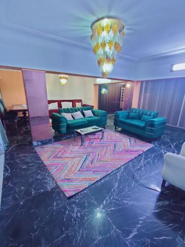 a lobby with blue couches and a rug at شقق Hs 4 in Cairo