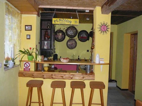 a kitchen with stools and plates on the wall at Private Světluška in Poběžovice